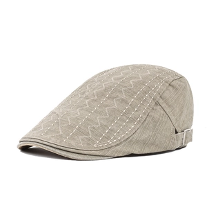 Detail of light khaki cotton ivy cap showing textured stitching and silver metal buckle