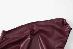 Detail of burgundy PU leather top showing fine double-stitching and smooth texture