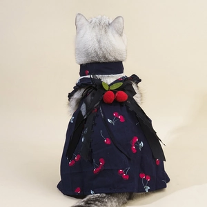 Navy pet wedding dress with cherry prints and a black bow on a silver cat model