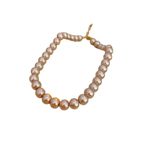 Elegant French vintage necklace featuring large peach pink round pearls with gold clasp