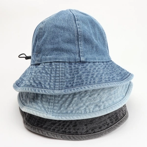 Three washed denim bucket hats in dark blue, light blue, and grey with adjustable drawstrings
