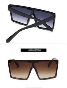 Detail view of square oversized sunglasses in classic black and leopard print frames