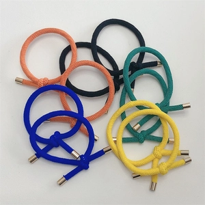 Close-up of colorful braided elastic hair ties with silver metal tube buckles detail