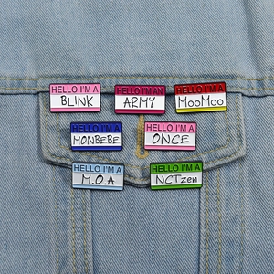 Colorful K-pop fan name enamel badges pinned on blue denim jacket pocket detail