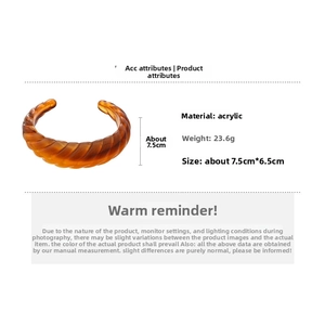 Detail view of amber acrylic bangle with twisted texture, weighing 23.6g and 7.5cm size
