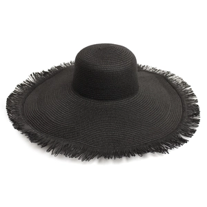 Close-up of black straw sun hat featuring large brim with bohemian tassel fringe edge