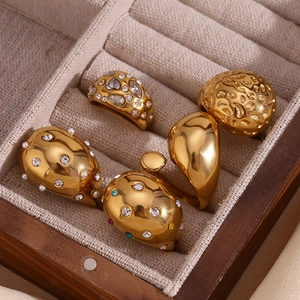 Detail of five 18K gold-plated teardrop rings with hammered textures and micro-inlaid rhinestones