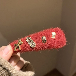 Red wool pony hairclip with gold wealth symbols for New Year luck and festive style