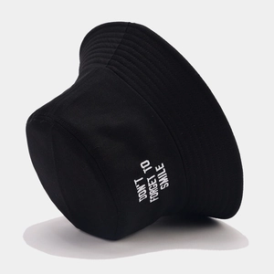 Black cotton bucket hat with white embroidery 'DON'T FORGET TO SMILE' on a grey background