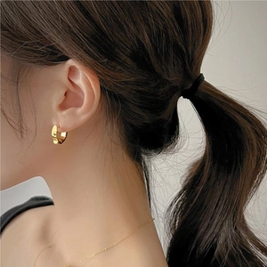 Elegant 925 sterling silver chunky hoop earrings in gold plating on model for daily wear