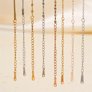 Detailed view of various metal necklace extension chains in gold, silver, and rose gold finishes