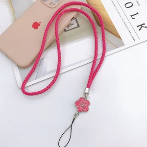 Detail of rose red braided phone lanyard with pink camellia pendant and sparkling rhinestone