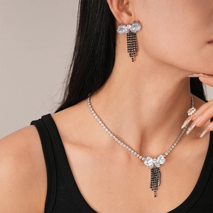 Close-up of luxury zircon butterfly necklace and earring set worn by a fashion model