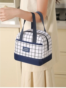 Close-up of a portable lunch bag with black and white gingham pattern and handles