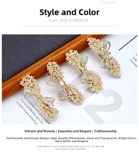 Detail of four golden bow hair clips with elegant pearls and sparkling rhinestones
