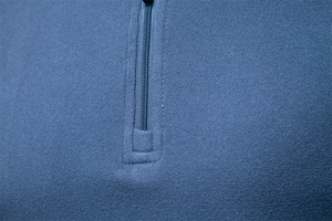 Detail of blue men's fleece sweatshirt showing the zipper design and soft fabric texture