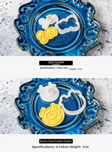 Detail of hand-pressed cookie molds showing 2021 and cartoon ox stamps for baking