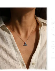 Detail of s925 silver mermaid tail necklace with blue gradient crystals on model