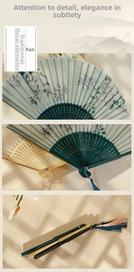 Detail of Chinese folding fan with floral print, bamboo ribs, and silk tassel charm