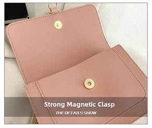 Detail view of the strong magnetic snap closure on a pink leather crossbody handbag