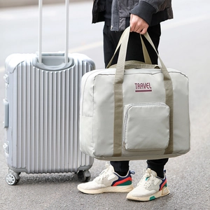 Green oxford fabric travel bag with large capacity shown on luggage handle for travel