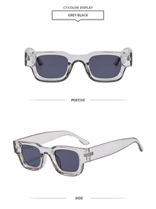 Detail view of retro square sunglasses with transparent grey frames and wide temples