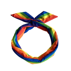 Detailed close-up of a rainbow striped knitted headband with a neat bow on white background