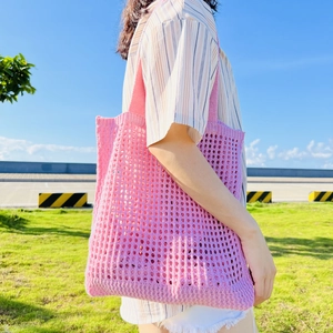 Minimalist knit hollow shoulder tote bag in bright pink for summer outdoor leisure style