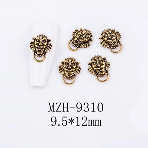 Detailed view of lion head alloy nail charms with rings in vintage gold finish