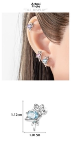 Detail showing heart-shaped zircon earrings with planetary rings and 1.12cm size label