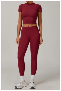 Detail of burgundy two-piece yoga set with crop top and high-waisted leggings