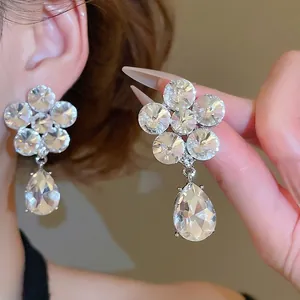 Sparkling crystal flower and teardrop earrings with silver needles and elegant design