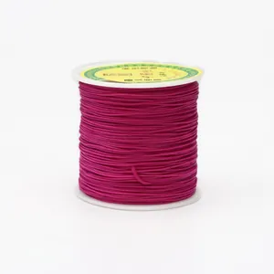 Close-up of 0.8mm rose red braided cord wound on a white spool for jewelry making