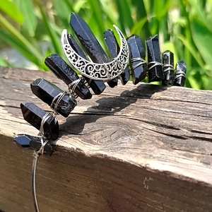 Detail of handmade wire-wrapped black crystal tiara with silver hollow moon accent