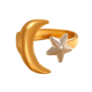 Macro detail of mixed gold moon and silver star ring with polished metallic finish