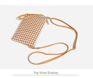 Top view of houndstooth woven crossbody bag with brown leather strap and gold zipper