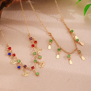Detail of bohemian gold layered necklaces with colorful rhinestones and evil eye pendants