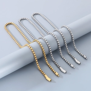 Close-up of gold and silver stainless steel box chains with unique magnetic clasp detail