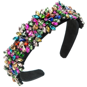 Close-up of wide headband featuring colorful multi-faceted crystals and velvet base