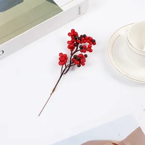 Detailed close-up of vibrant red artificial holly berry branch for festive home decor