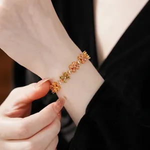 Exquisite gold floral bracelet with multi-color zircon petals on a wrist model