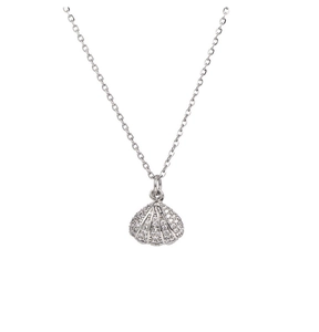 Macro shot of shell pendant with pavé set cubic zirconia on a silver-plated chain