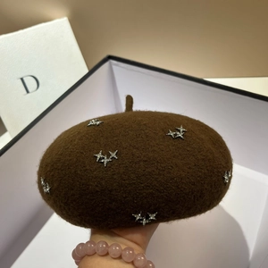 Detail showing plush dark brown wool beret with shiny silver star rhinestone accents
