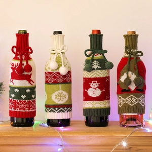 Knitted Christmas wine bottle covers with reindeer, snowman, and tree patterns