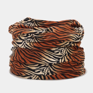 Detail of soft leopard print beanie scarf with vibrant orange and black animal patterns