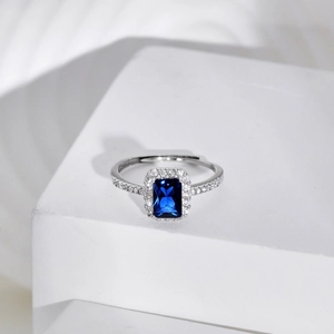 Macro detail of S925 silver ring featuring blue rhombus zircon and pavé crystal accents