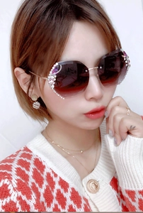 Detail of luxury oversized sunglasses with gradient lenses and sparkling rhinestone trim