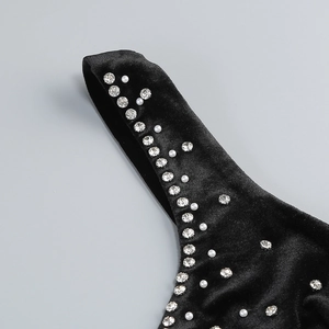 Detail of silver rhinestones and white pearls on premium black velvet evening dress
