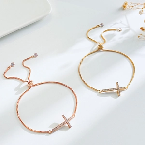Adjustable cross bracelets with sparkling cubic zirconia in gold and rose gold finishes