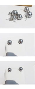 Macro view of silver-gray pearl stud earrings in single and double bead designs
